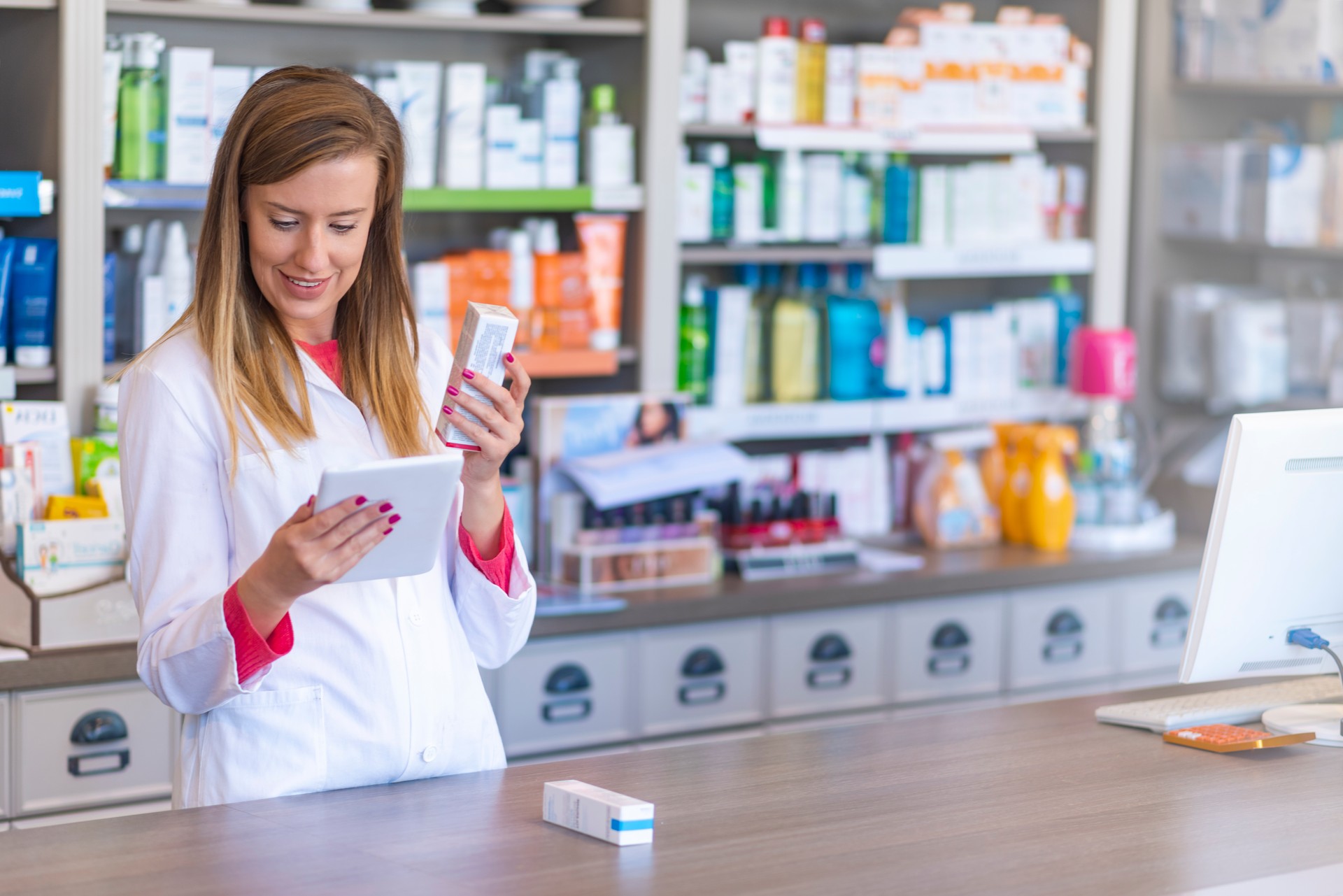 Portrait of pharmacist holding digital tablet in pharmacy